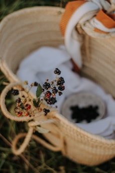 A basket filled with assorted blackberry products like jams and preserves.