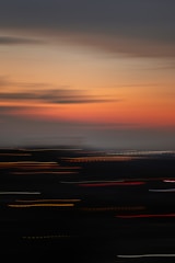 Dynamic wing curve design overlaying a blurred cityscape at night.