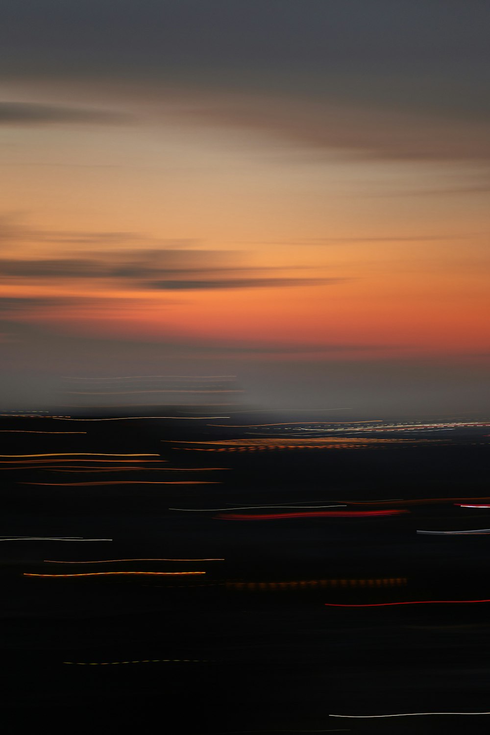 a plane is flying in the sky at sunset