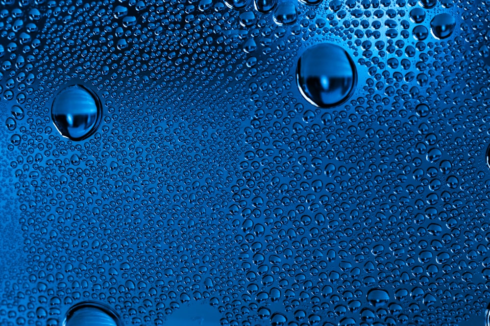 a blue background with water drops on it