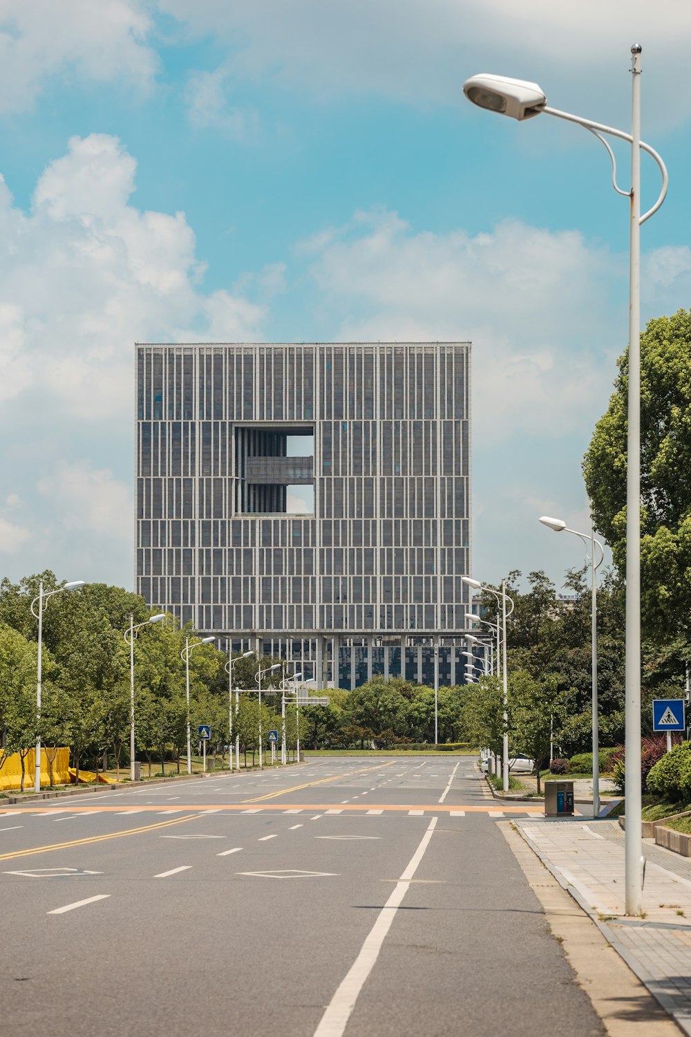 an empty street in front of a tall building