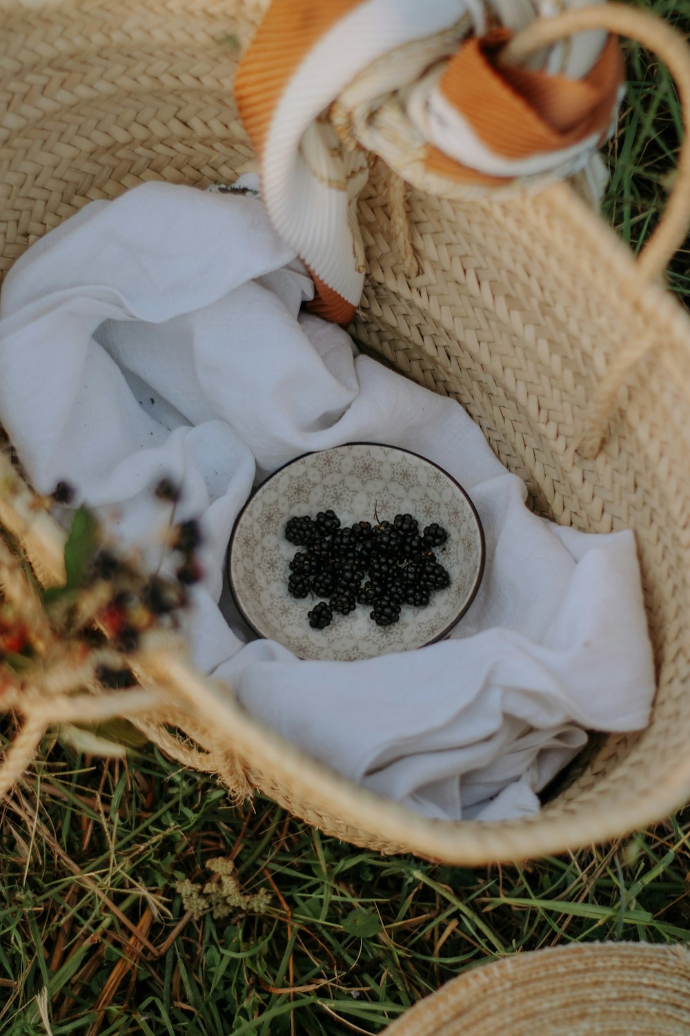 a basket filled with a white cloth and some black beads