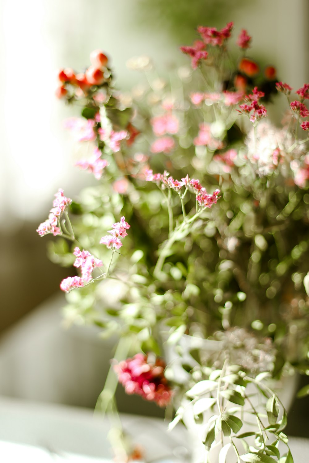 a vase filled with pink flowers on top of a table