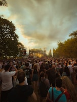 A scenic outdoor performance showcasing an energetic crowd.
