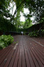 Private deck with comfortable seating surrounded by lush greenery.