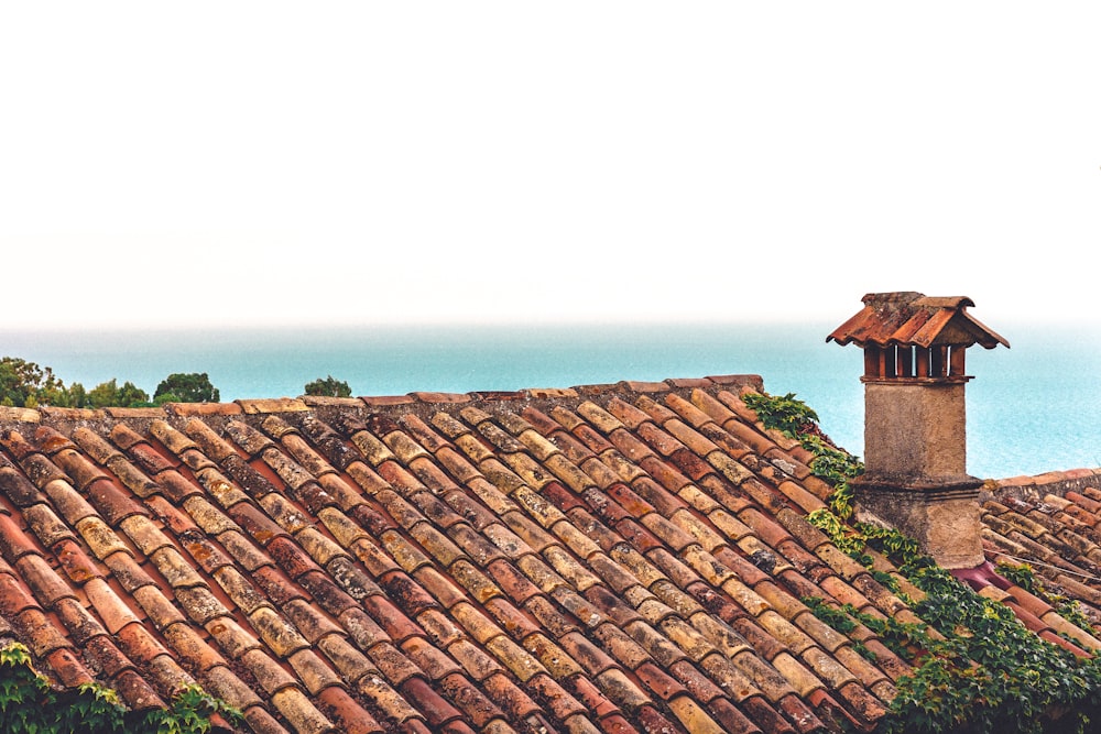 a view of a tiled roof with a clock tower