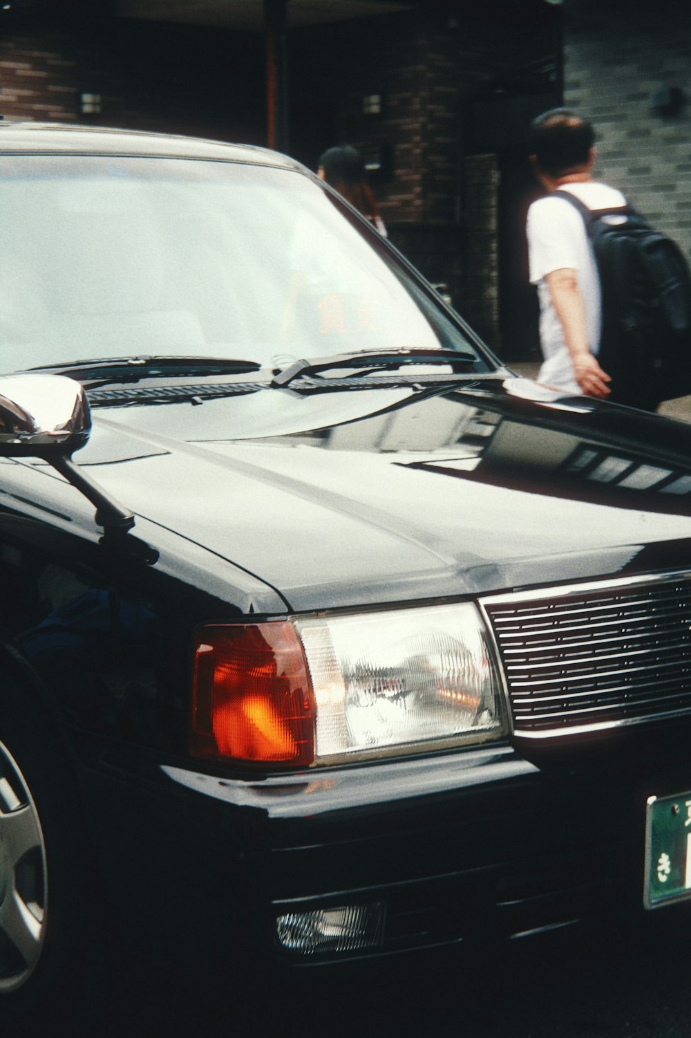 a black car parked on the side of the road