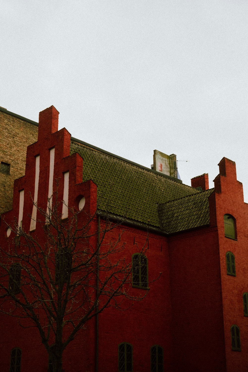 a red building with a clock on the top of it