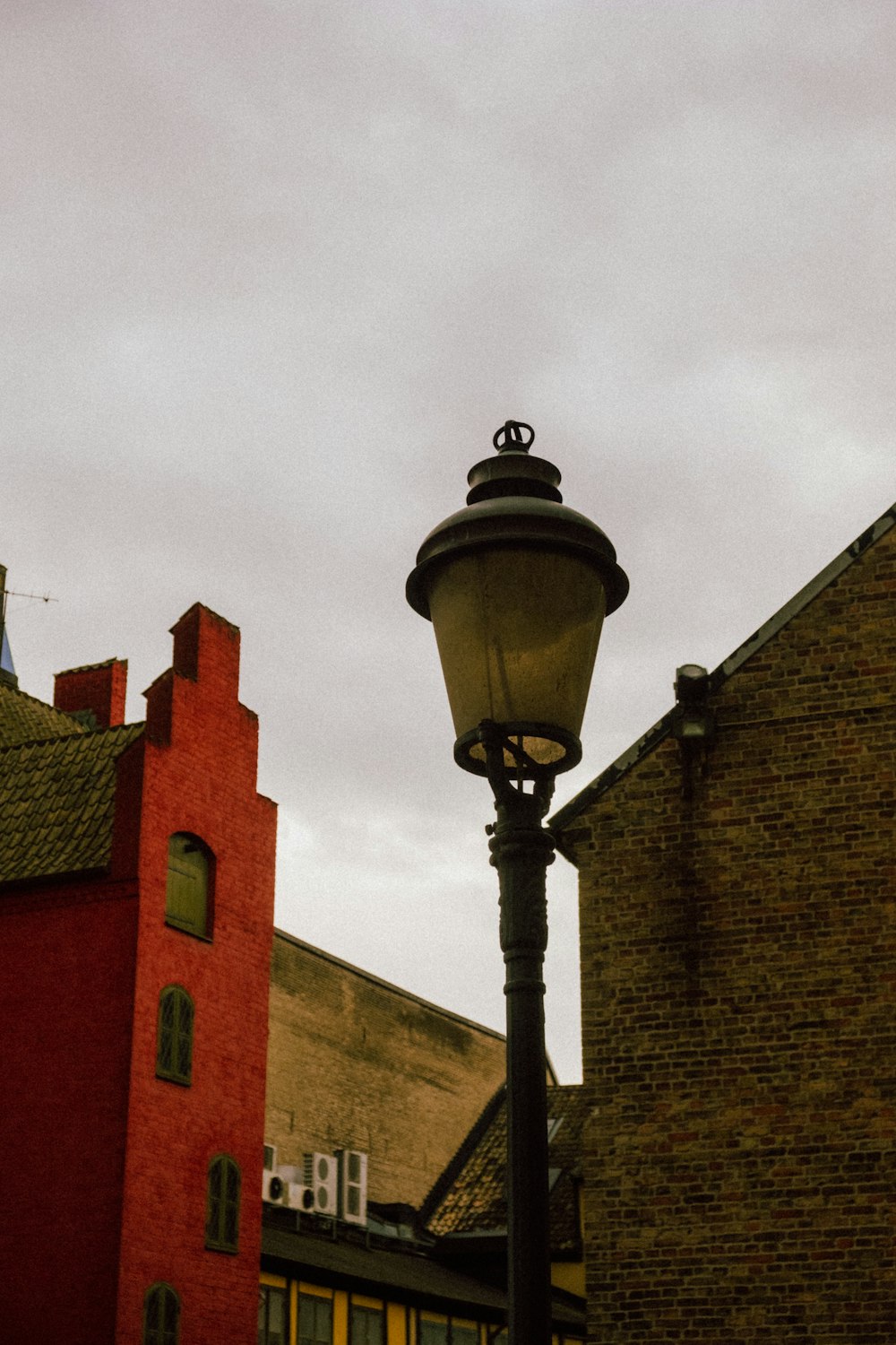 a street light in front of a brick building