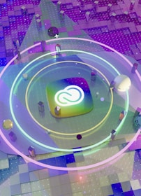 A colorful and futuristic digital artwork featuring a central logo surrounded by concentric neon rings. The background consists of a gradient of squares in purple and blue tones, with floating geometric shapes and a scattering of small lights.