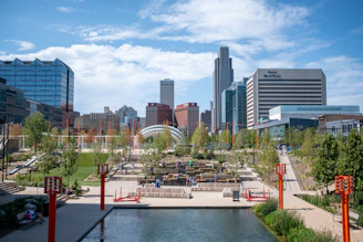 a view of a city with a lake in the foreground