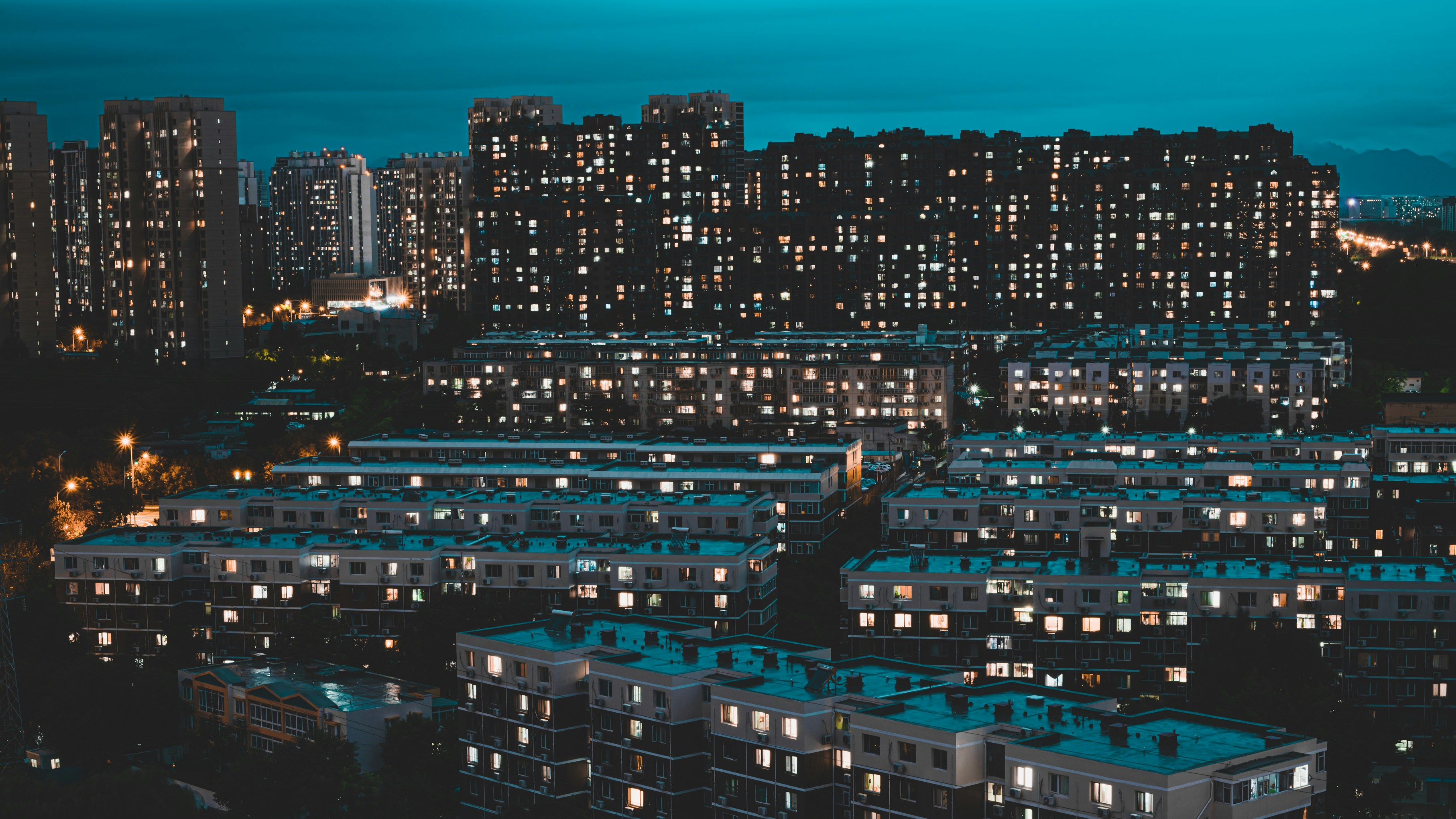 a city with lots of tall buildings lit up at night