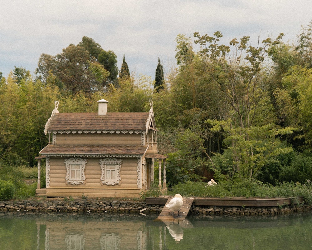 a house sitting on the edge of a body of water