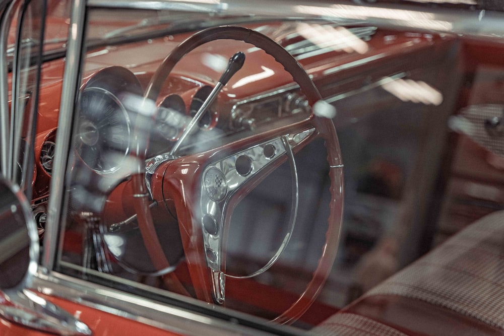 a red car with a steering wheel and dashboard