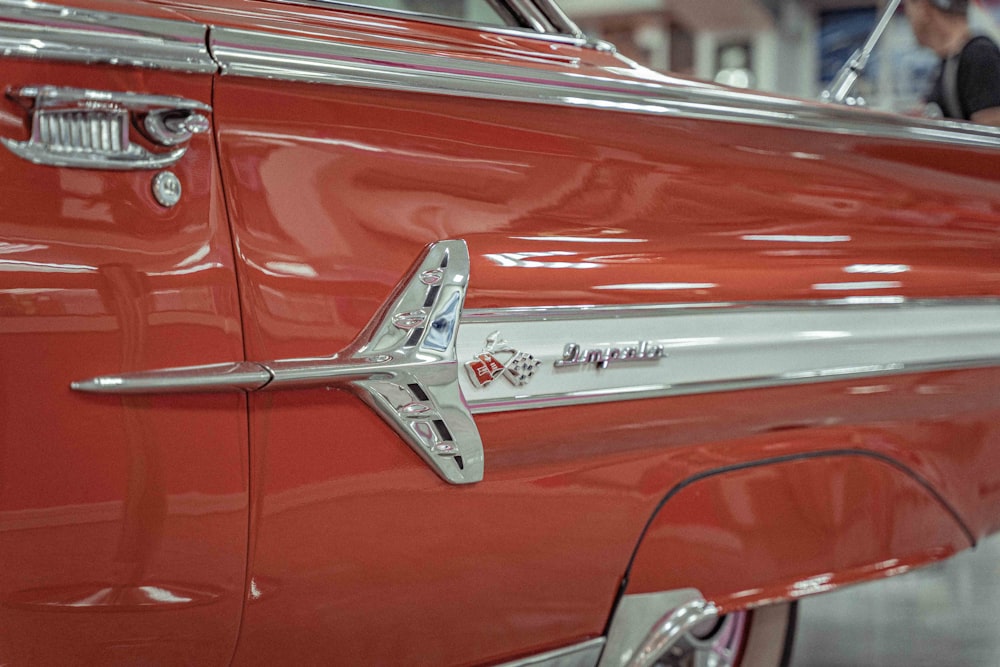 a close up of a red car with chrome trim
