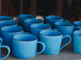A collection of personalized mugs featuring bold blue graphics.