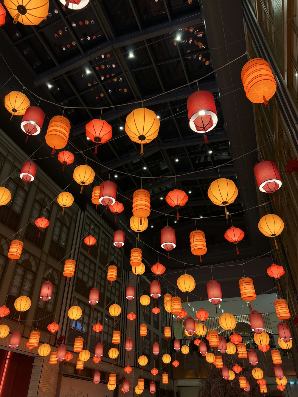 a room filled with lots of red and orange lanterns