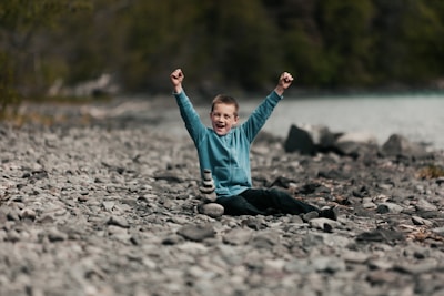 A joyful child celebrating a small achievement with a therapist in a cozy corner