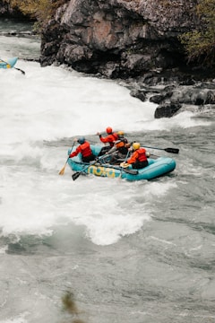 Group of friends navigating rapids on a bright sunny day during a rafting trip.