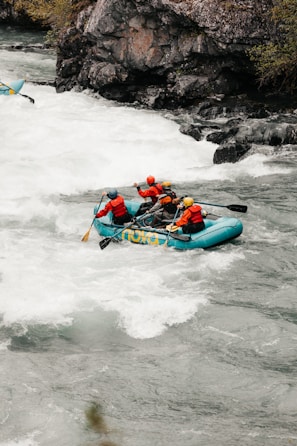 Group of adventurers navigating rapids on a sunny day in San Gil river.