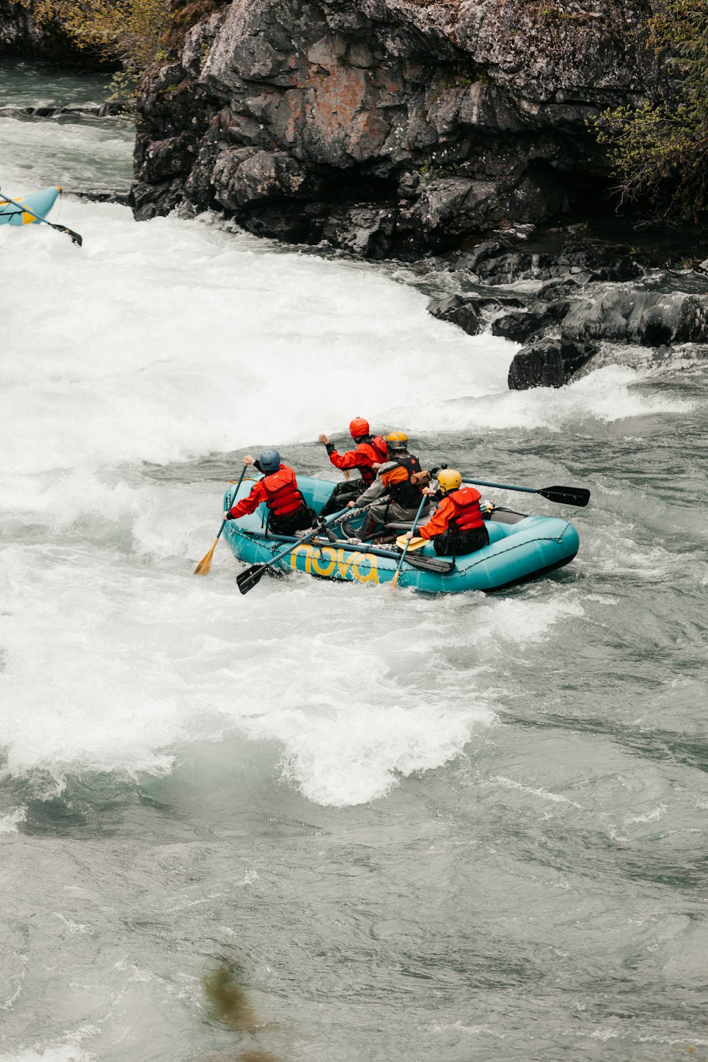 a group of people in a raft on a river