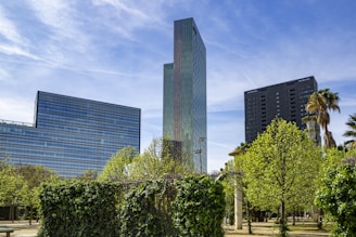 a tall building sitting next to a lush green park