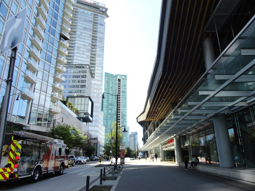 a city street with tall buildings and a fire truck