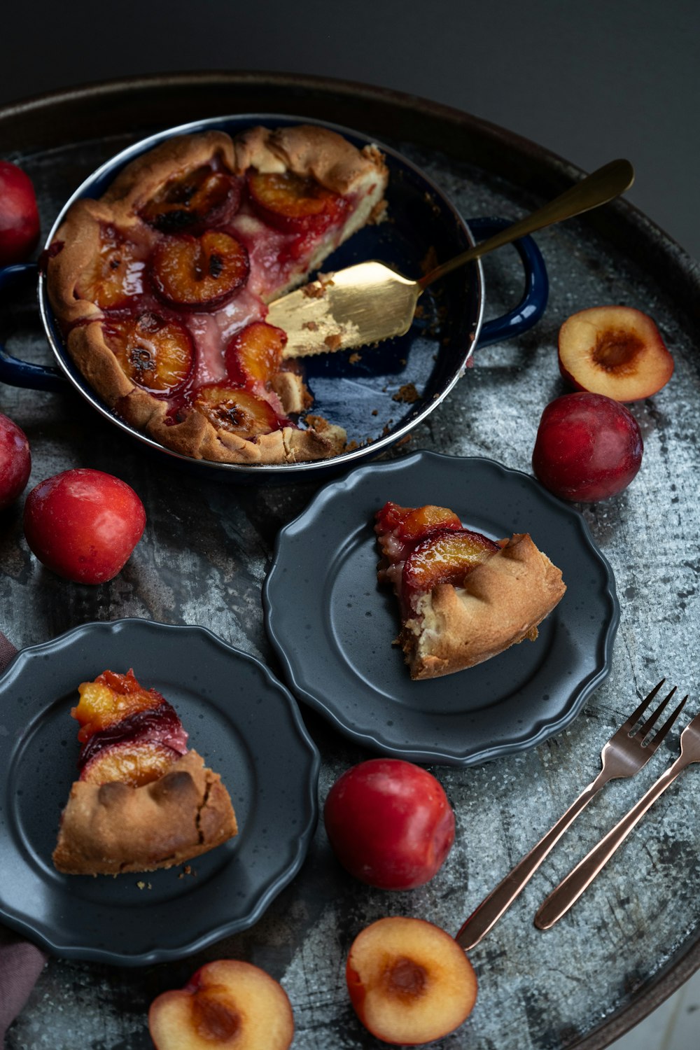 a table topped with plates of pie and fruit