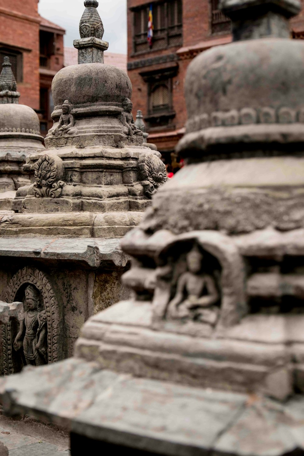a group of stone statues in front of a building