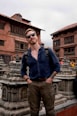 a man with a backpack standing in front of a building