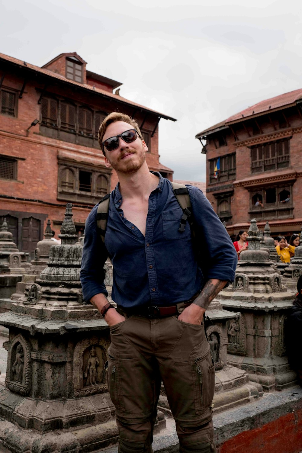 a man with a backpack standing in front of a building