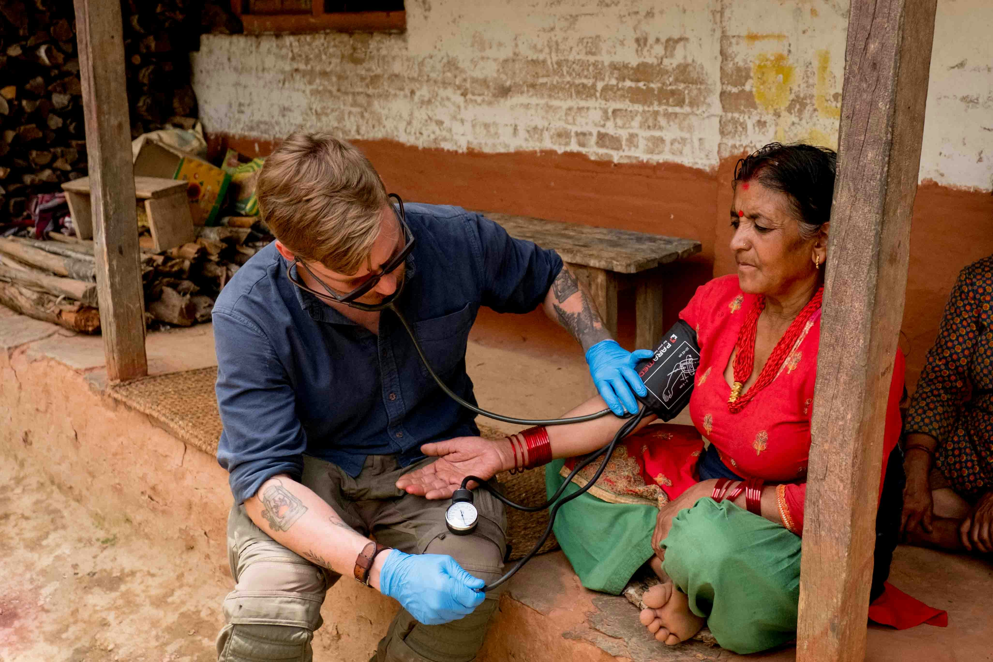 Healthcare professional providing medical care at patient's home