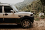 Spacious silver SUV parked near a vineyard with rolling hills in the background.