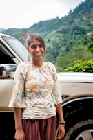 A young woman casting her vote with a hopeful smile at a rural polling booth.
