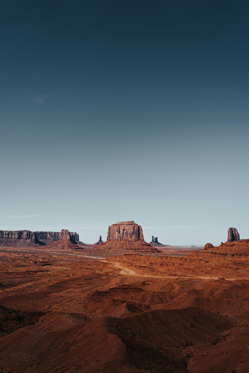 a dirt road in the middle of a desert