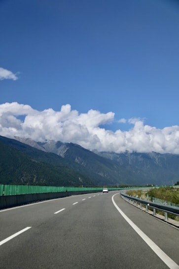 A scenic highway winding through mountains under a clear blue sky.