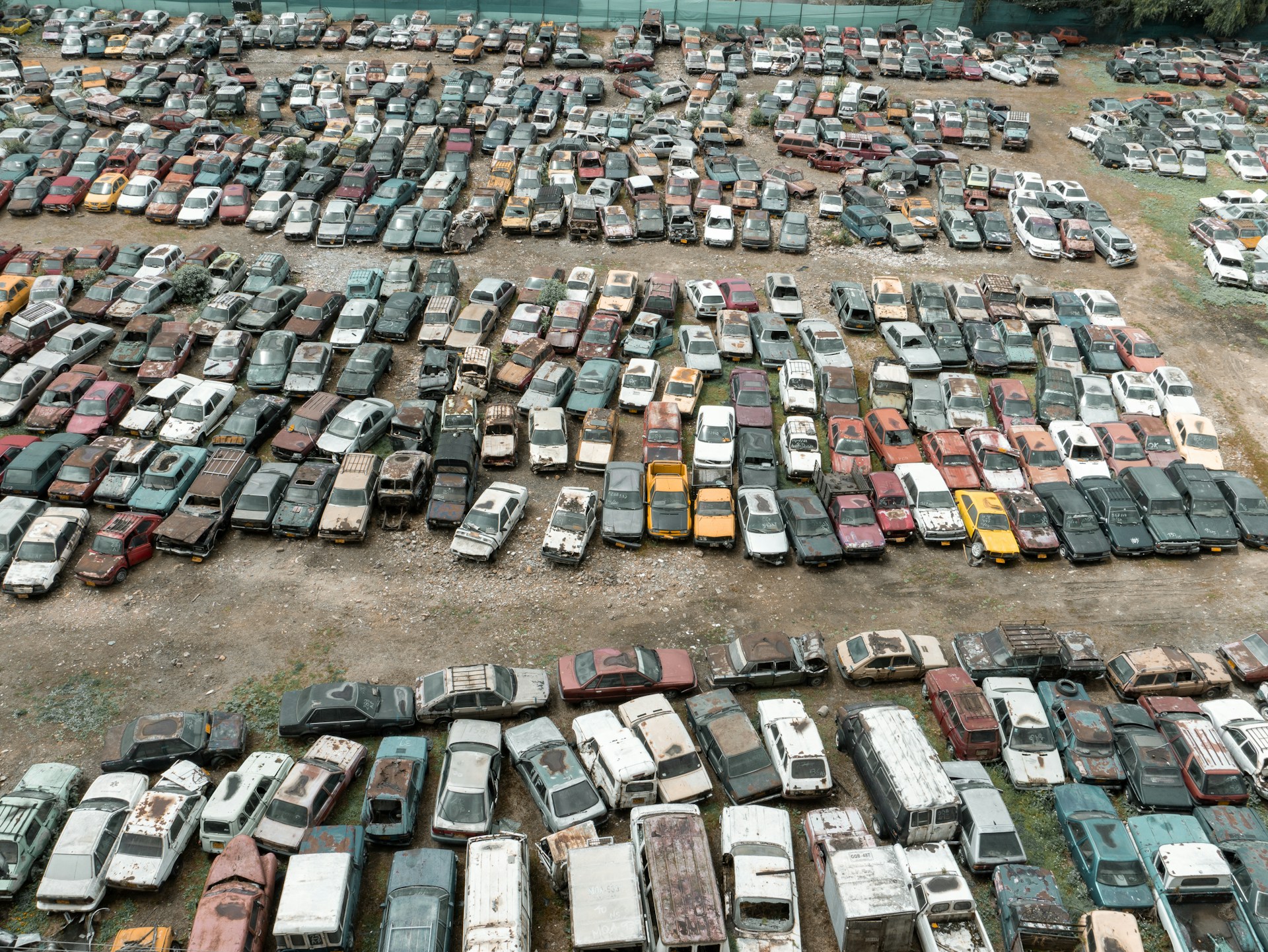 a parking lot full of old cars and trucks