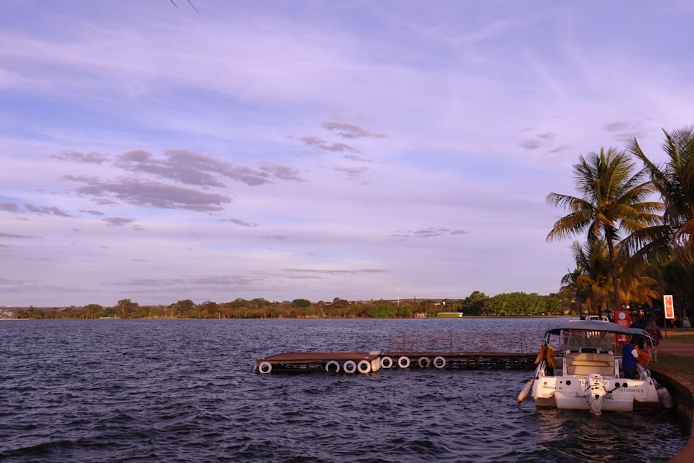 a boat is docked at the end of a pier