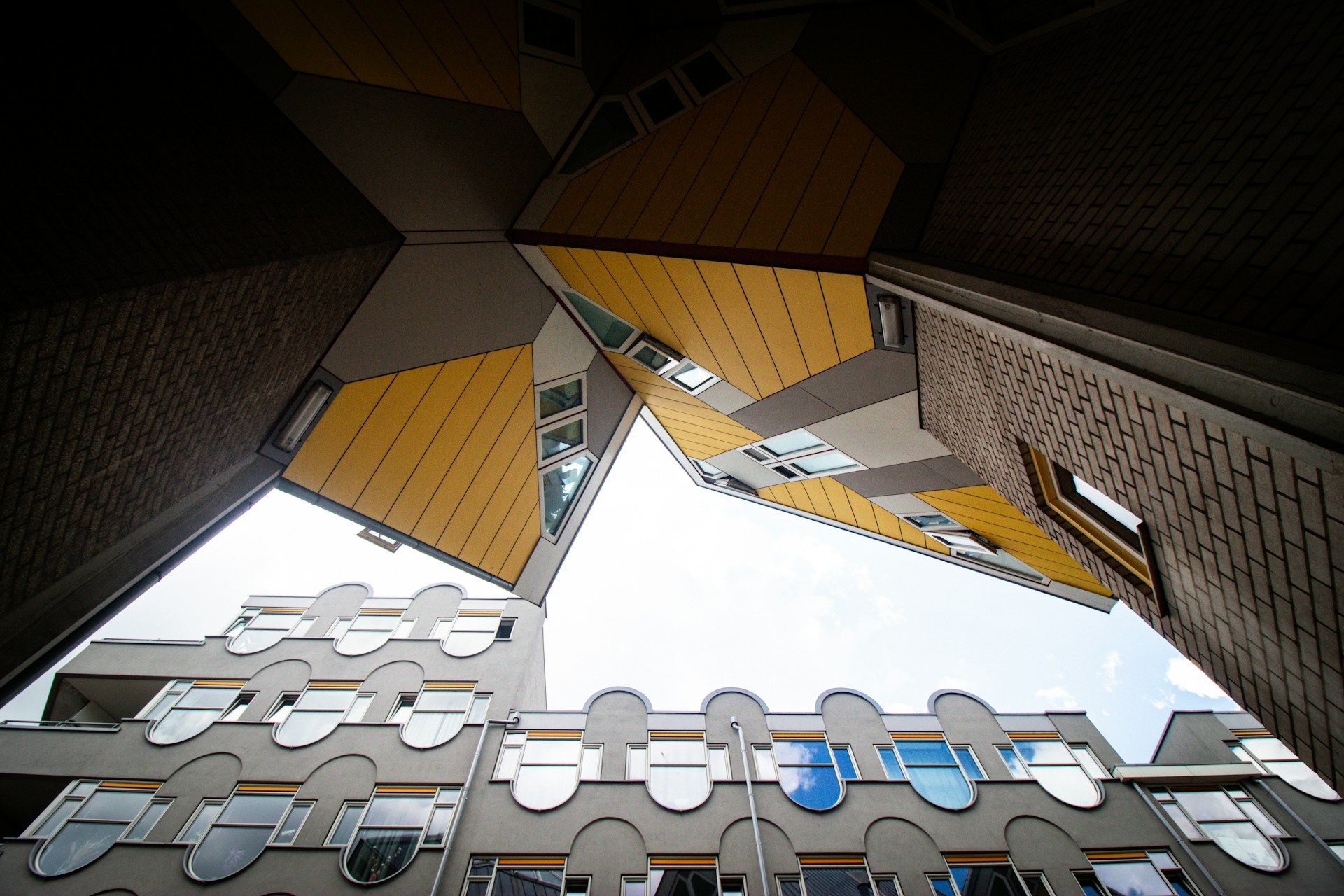 A dramatic aerial shot from a drone showing geometric patterns of city architecture under moody lighting.