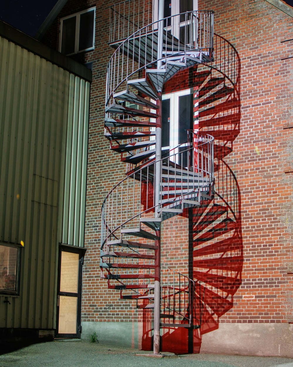 a spiral staircase painted on the side of a building