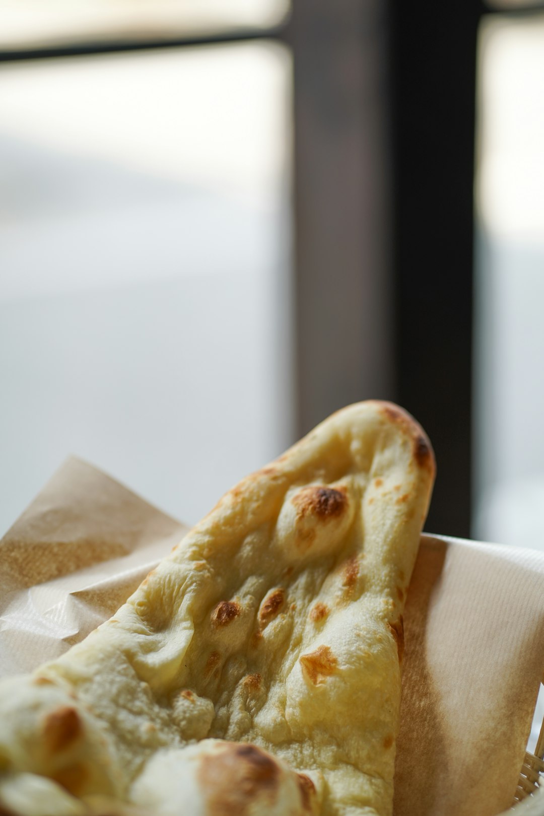 a slice of pizza sitting on top of a napkin