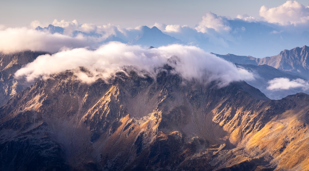 a view of a mountain range covered in clouds