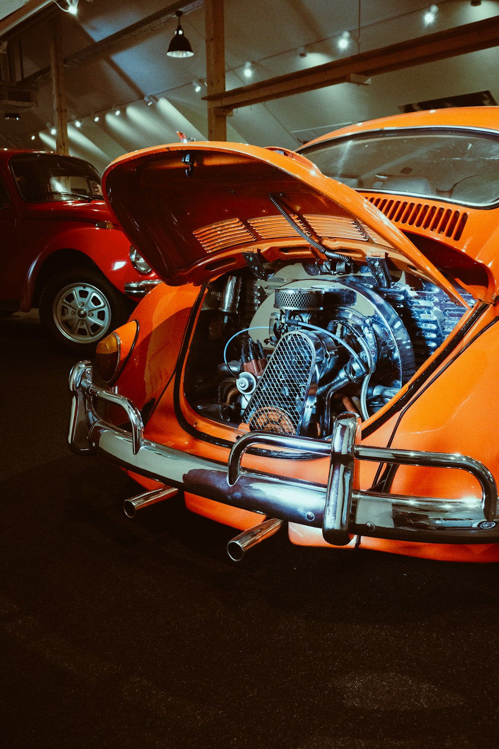 an orange car with a motorcycle engine in it's trunk