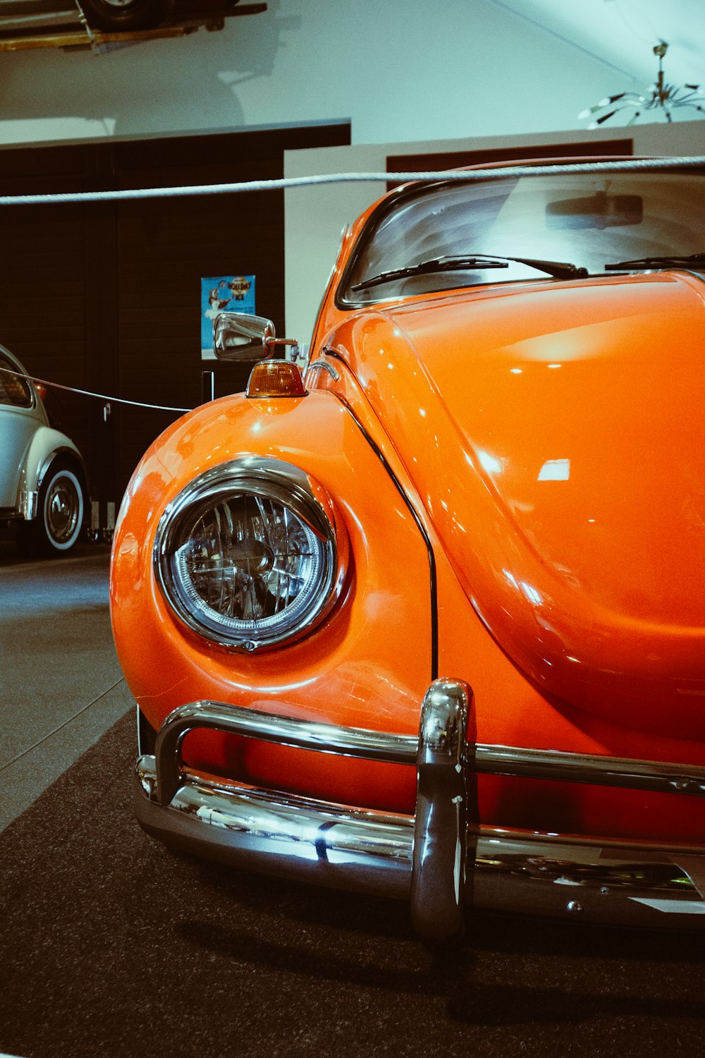 an orange vw bug is on display in a museum