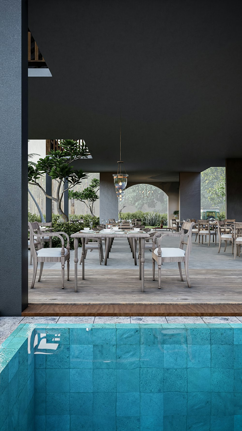 a swimming pool with tables and chairs next to it