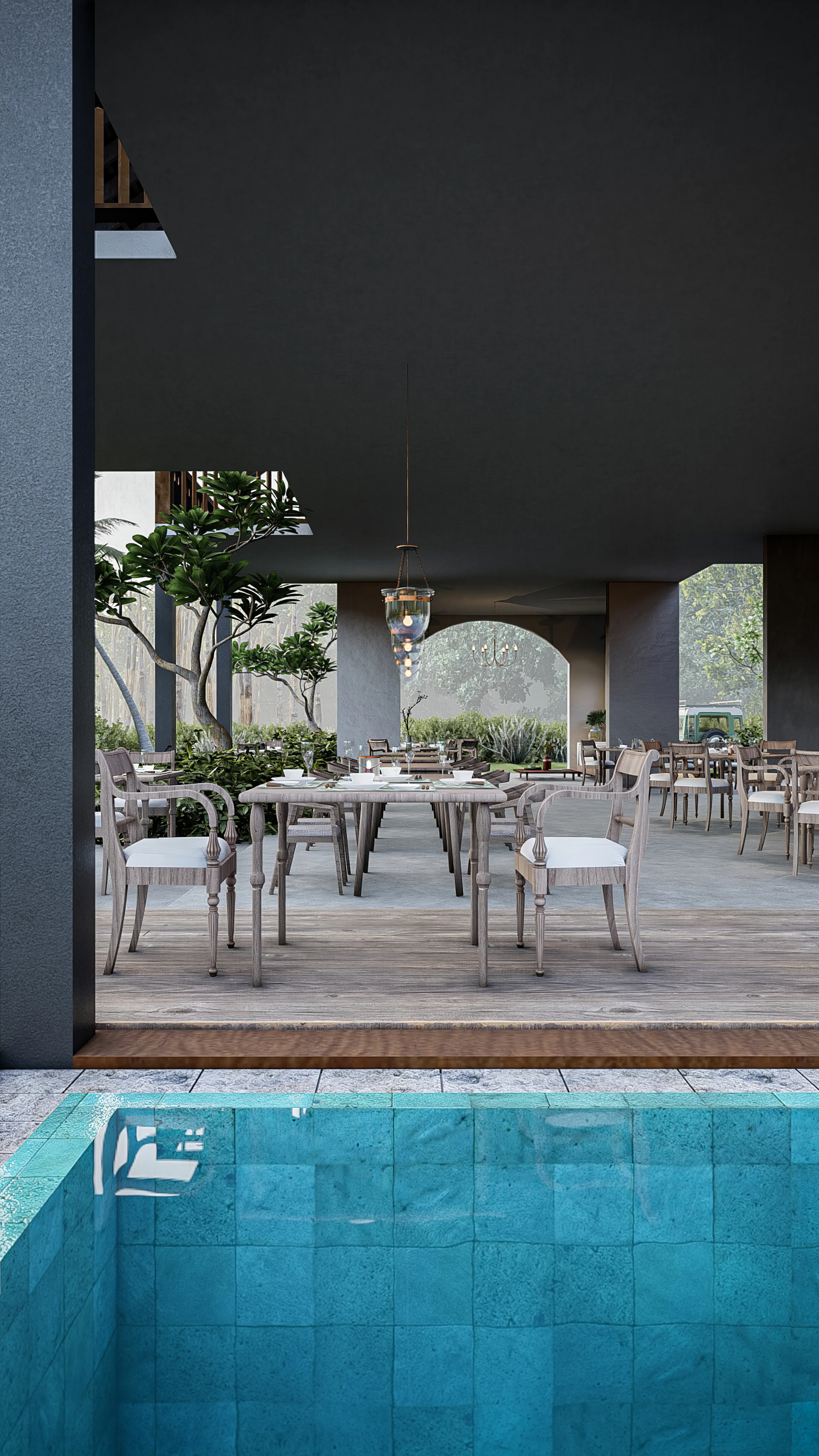 Elegant outdoor seating area by the pool with warm lighting and cozy cushions, perfect for evening gatherings.