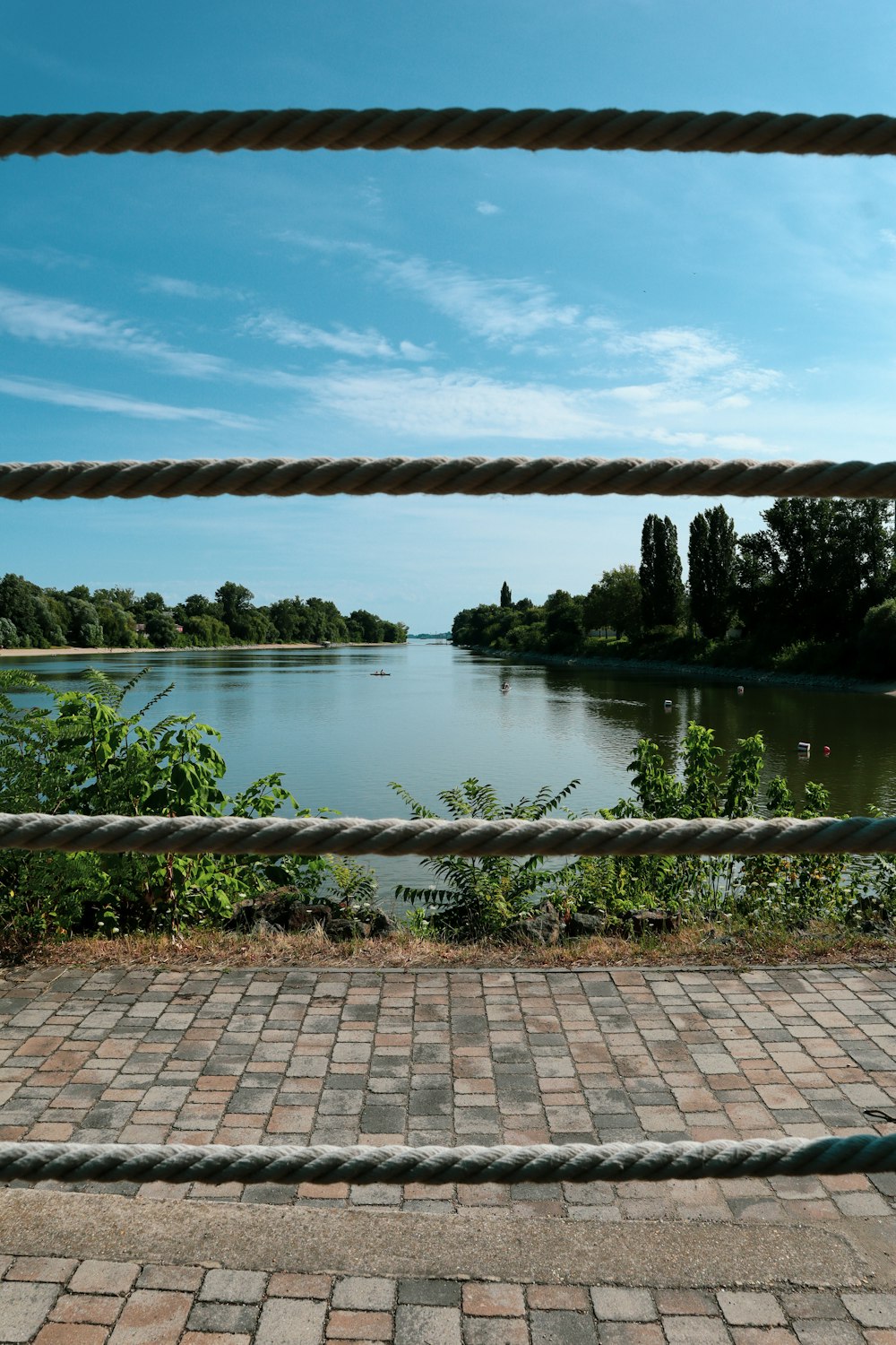 a view of a body of water through a fence