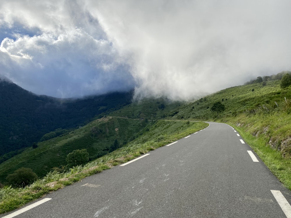 an empty road with a mountain in the background