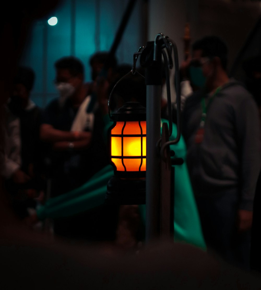 a group of people standing around a yellow light