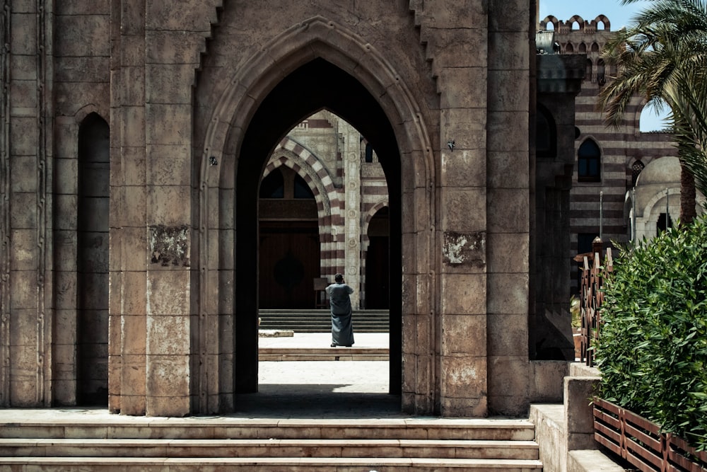 a person standing in a doorway of a building